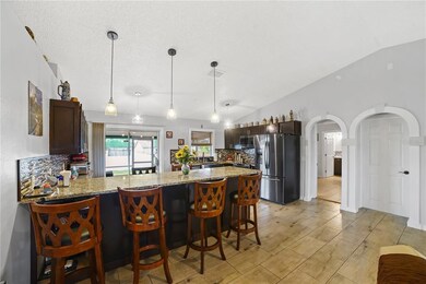 Kitchen bar. Owner's Suite and garage at right.