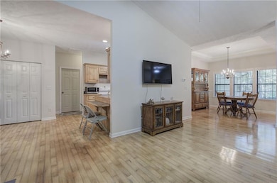 The Great Room features hardwood floors, a vaulted ceiling, a gas-log fireplace, and has plenty of room for furniture placement.
