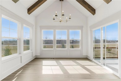 Unfurnished sunroom featuring a chandelier, lofted ceiling with beams, and visible vents