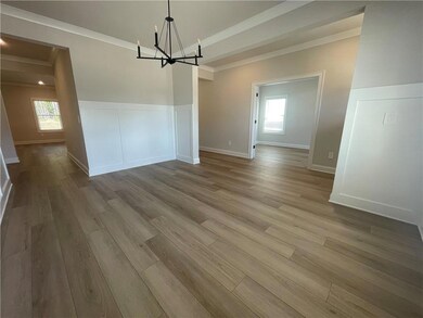 Unfurnished dining area with ornamental molding, a