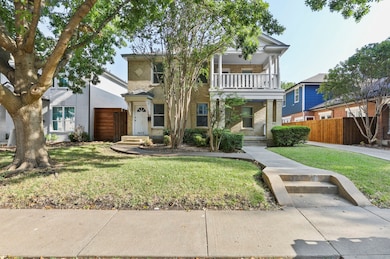 View of front of home featuring brick siding and a balcony