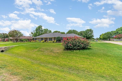 Single story home featuring a front lawn