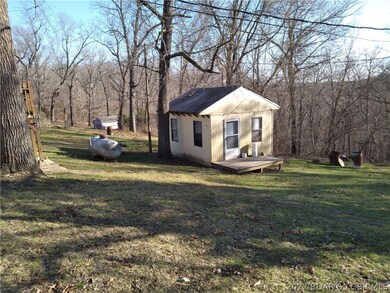 Large back yard with fixer-upper he/she shed