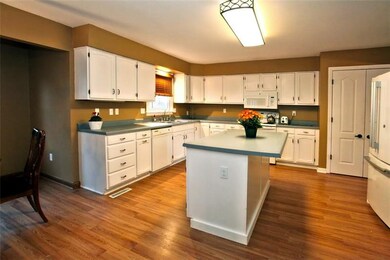 Large Kitchen with wood laminate floors, island, p