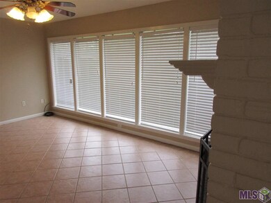 Wall of windows in den with views to fenced back y