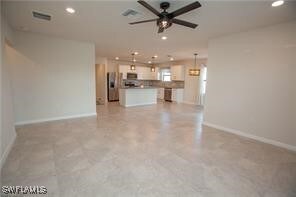 Unfurnished living room with recessed lighting, ba