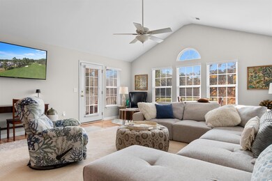 Living room featuring ceiling fan, light hardwood 