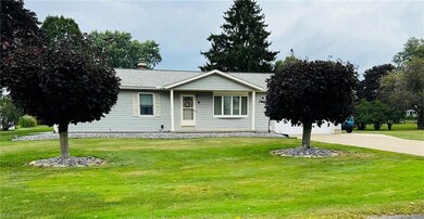 Single story home featuring a front lawn