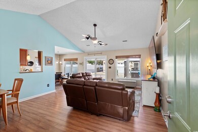 Living room with high vaulted ceiling, hardwood / 