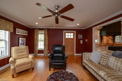Comfortable living room with gas logs opens onto kitchen