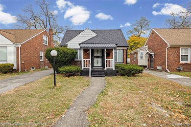 Bungalow-style home with brick siding, a front lawn, and roof with shingles