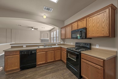 Kitchen with a peninsula, a sink, visible vents, 