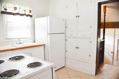 Kitchen has a ceramic tile floor and built-in pant
