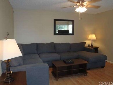 Spacious living room with laminate flooring and ce