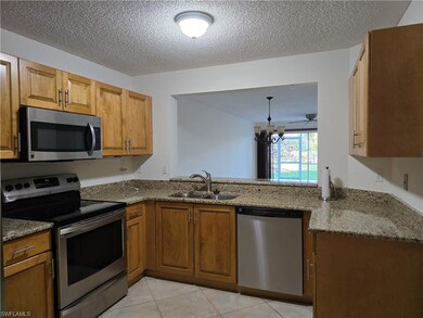 Kitchen with stainless steel appliances, sink, granite countertops, and kitchen peninsula