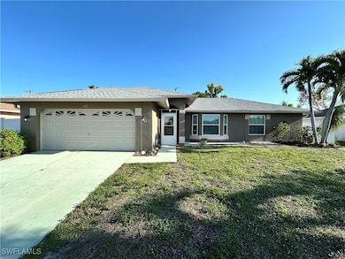 Ranch-style home with a garage, stucco siding, con