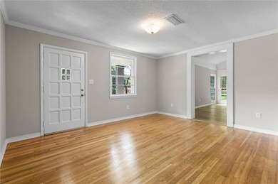 Entryway featuring a textured ceiling, plenty of n