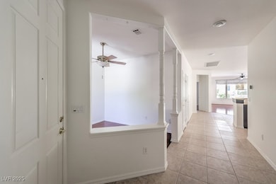 Hall with light tile patterned floors and baseboards