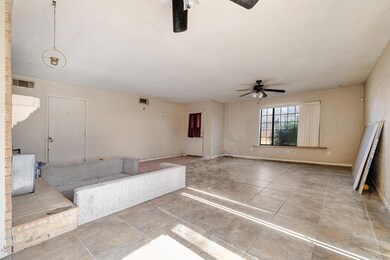 Unfurnished living room with ceiling fan