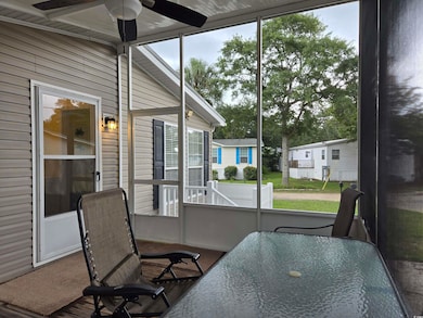 Sunroom featuring a wealth of natural light and ceiling fan