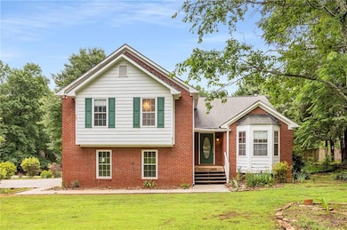 View of front of house with a front lawn and brick siding