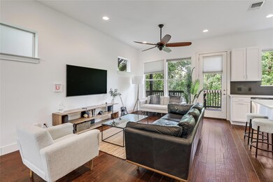 Living area featuring ceiling fan, plenty of natu
