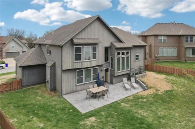 Back of property with a patio, a shingled roof, a fenced backyard, and a yard
