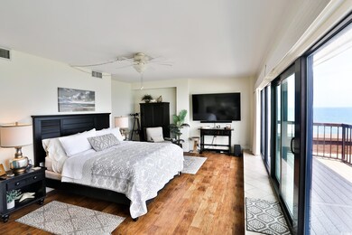 Primary bedroom with wall-to-wall, floor-to-ceilin