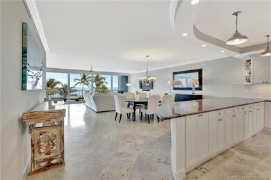 A long sweep of the kitchen, living-dining room en