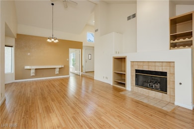Unfurnished living room featuring high vaulted cei