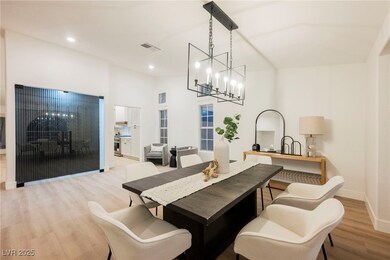 Dining area with wood finished floors, a chandelie