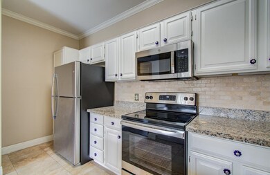 Another view of kitchen featuring stainless steel