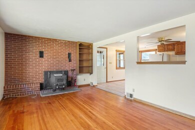 With wood stove insert and hardwood floors