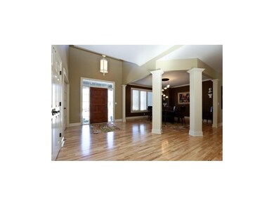 Foyer with grand entry and maple hardwood floors