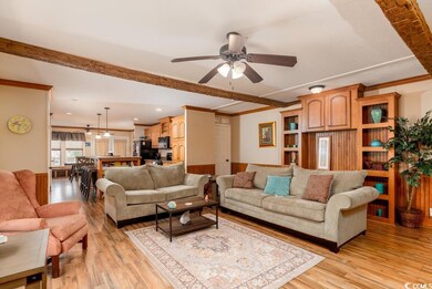 Living room with ceiling fan, light hardwood / woo