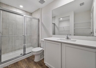 Full bath featuring a walk in closet, vanity, a st