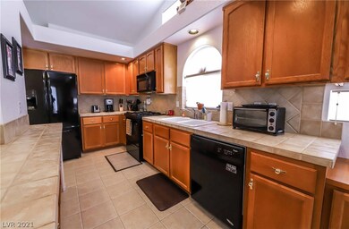 Gourmet kitchen features extended cabinets, tile,
