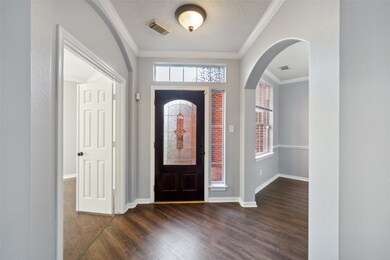 Welcoming entryway featuring a dark wood floor tha