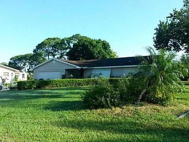 Exterior Front. Screened entry and Bahama style sh