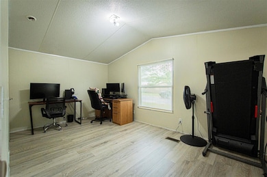 Office area with light wood-type flooring, lofted