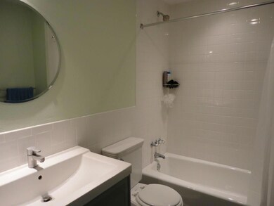 Bathroom with shower / bath combo, tile walls, va