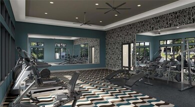 Gym featuring ceiling fan, a raised ceiling, and recessed lighting