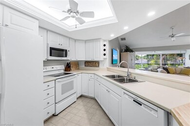 Kitchen with white cabinets, sink, ceiling fan, an