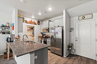 Kitchen featuring stainless steel appliances, a si