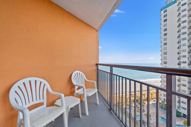 Balcony featuring a view of the beach and a water view