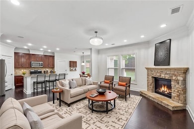 Living area with crown molding, baseboards, visibl