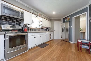 Dining room featuring dark wood-style flooring, recessed lighting, and healthy amount of natural light