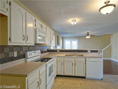 Kitchen. Notice the beautiful tile backsplash and new countertops in neutral colors.  This kitchen will soon become the heart of you new home.