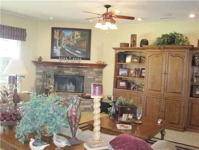 Family room with gas fireplace and windows that look out onto the view
