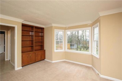At one end of the living room is a bay window which overlooks the backyard. 